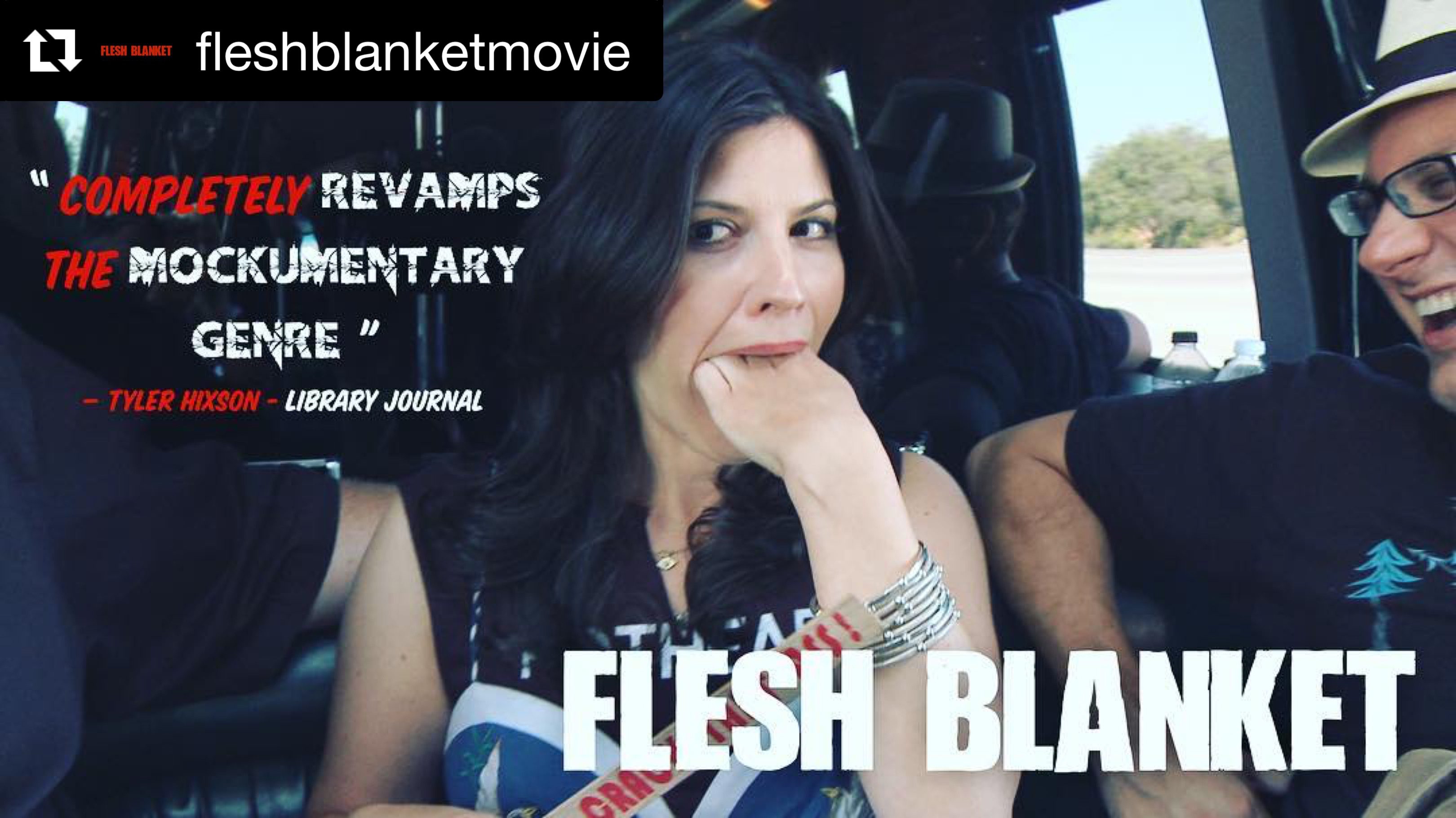 Woman with black hair posing in a car, wearing a Flesh Black shirt.